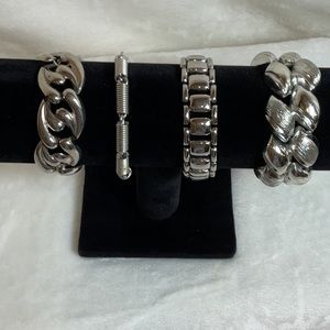 Set a four silver ton metal bracelets with clasps. various designs